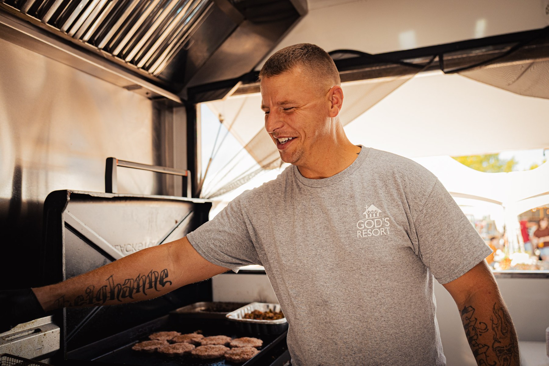 Cooking on the flat top inside The Lord's Kitchen food truck